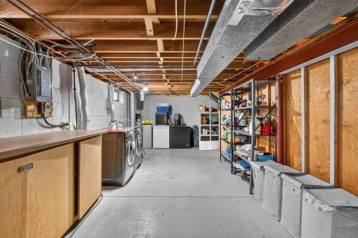 Generous utility and storage area with laundry and plenty of room to organize.