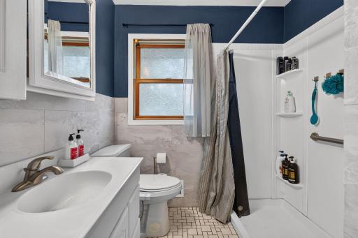 Accessible updated main level bathroom with modern tile work.