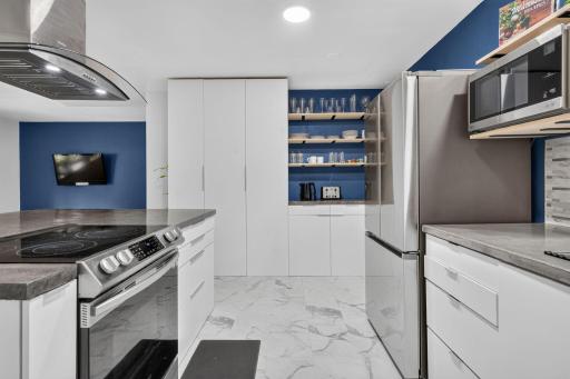 Plenty of storage with a mix of cabinetry and open shelving.