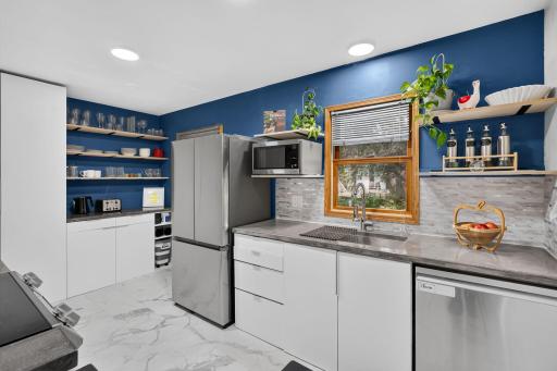 Stylish kitchen with open shelving and a pop of color.