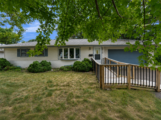 Welcoming one-level home surrounded by mature trees.