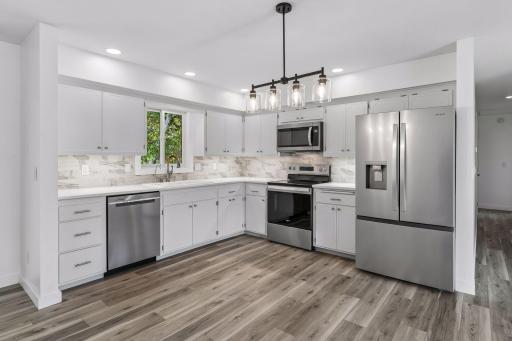 The kitchen offers an abundance of cabinet and countertop space