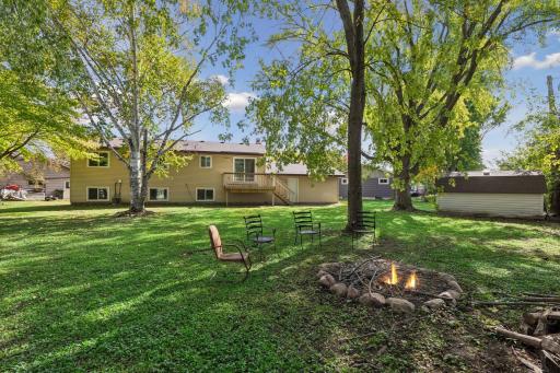 Enjoy relaxing by the fire pit overlooking the beautiful private backyard