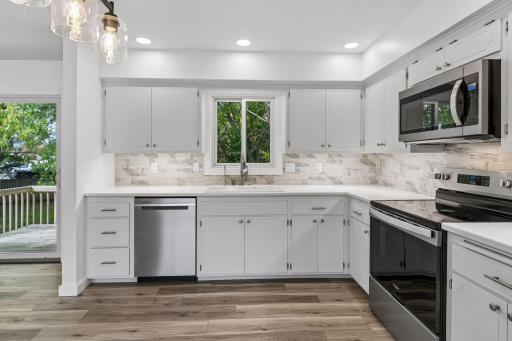 Kitchen with Corian countertops and tile backsplash