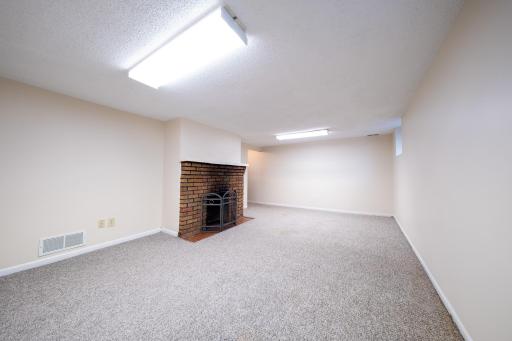 Featuring a second fireplace and cozy carpet