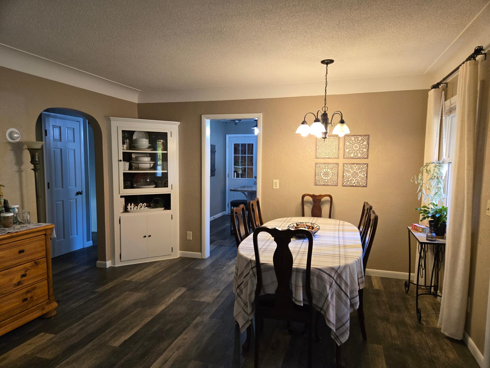 Inviting dining area featuring attractive flooring, warm neutral tones, and convenient access to the kitchen.