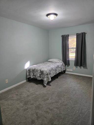 Bright and inviting main-level bedroom offering generous floor space and flexibility for a variety of furniture arrangements.