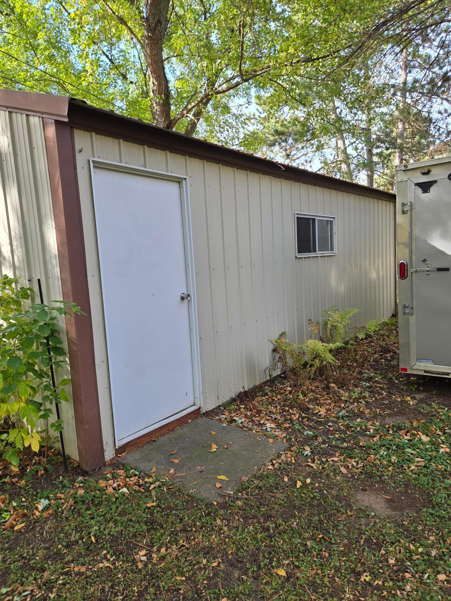 Convenient side entry door and window provide additional access and natural light to this versatile outbuilding.