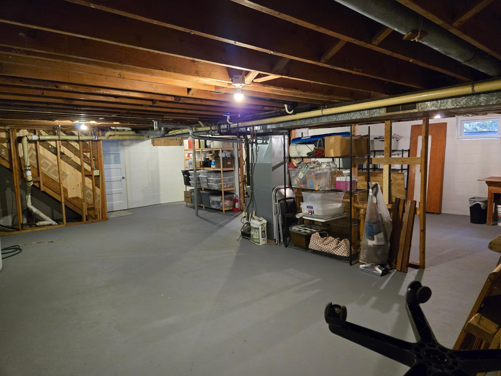 Spacious unfinished lower level offering an abundance of storage space and flexibility for future possibilities.