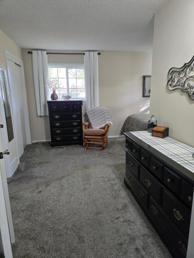Additional view of the primary bedroom highlighting the generous floor space, natural light, and flexibility for bedroom furnishings.