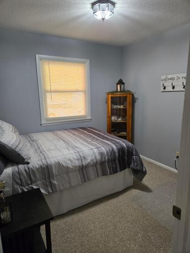 Comfortable main-level bedroom featuring neutral finishes, natural light, and space for bedroom furnishings.