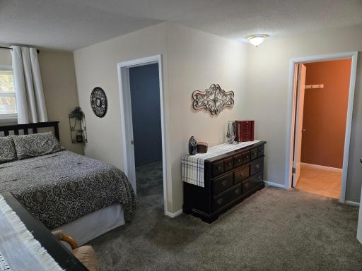 Comfortable primary bedroom featuring a cozy sleeping area, ample room for furniture, and a versatile layout.