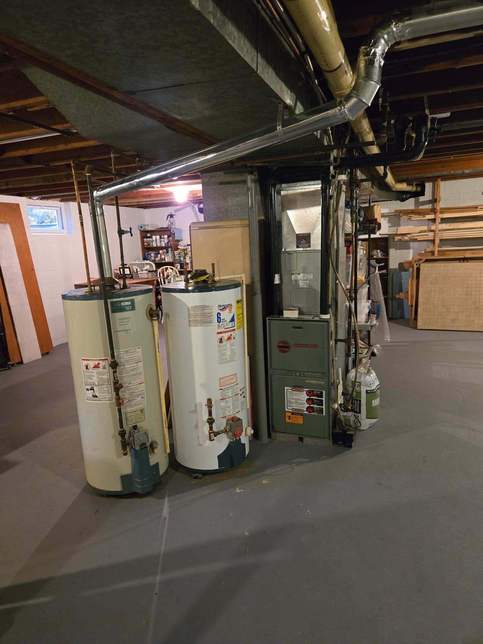 A new, unused water heater is also included but has not been installed, as the existing water heater remains operational.