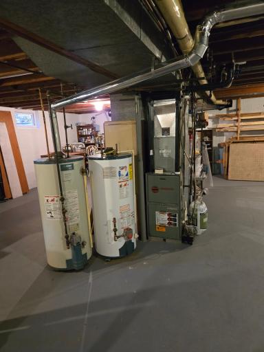 A new, unused water heater is also included but has not been installed, as the existing water heater remains operational.