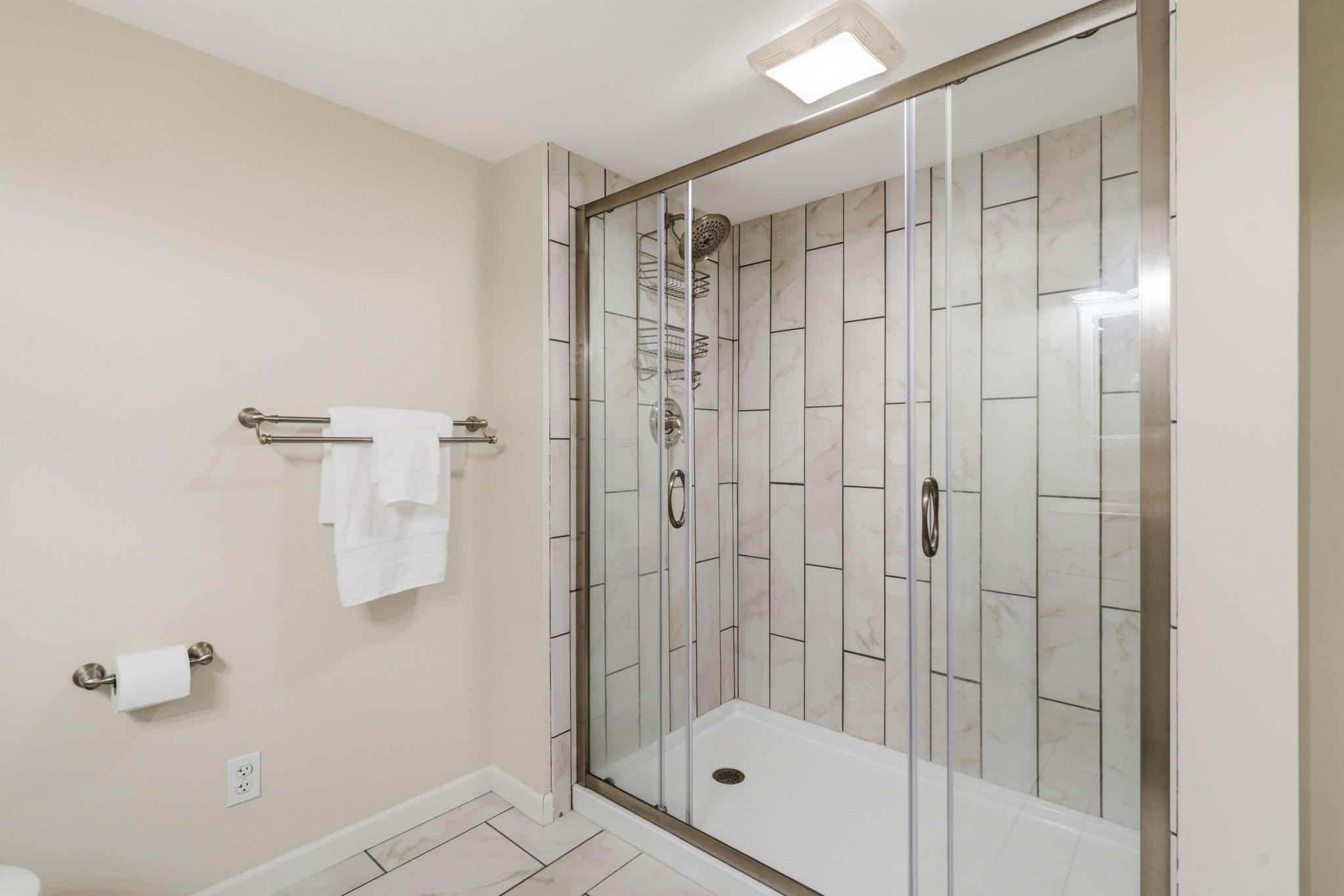 Lower 3/4 bath features awesome tile shower and tiled floors
