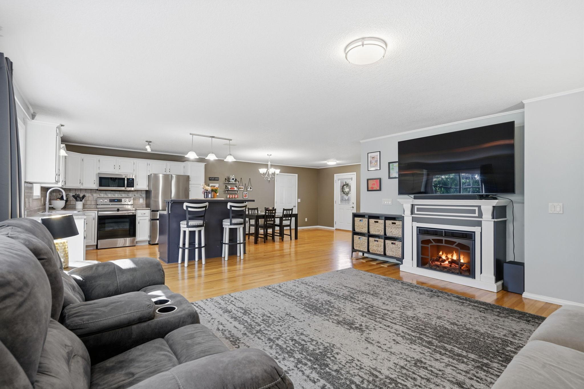 Spacious living area offering neutral paint & fireplace... cozy up to watch your favorite movie or Sunday football!