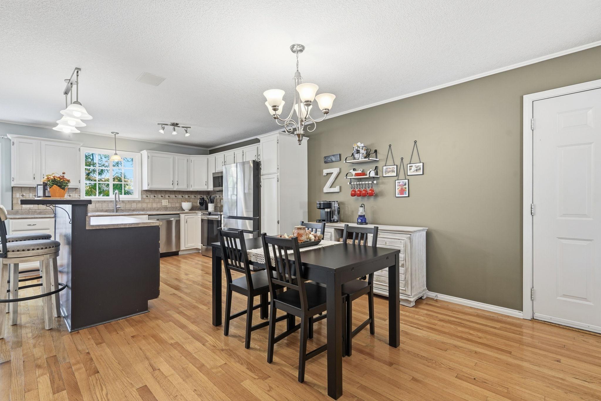 Dining area just off the kitchen with natural hardwood flooring.. plenty of room here for a large table and hosting!