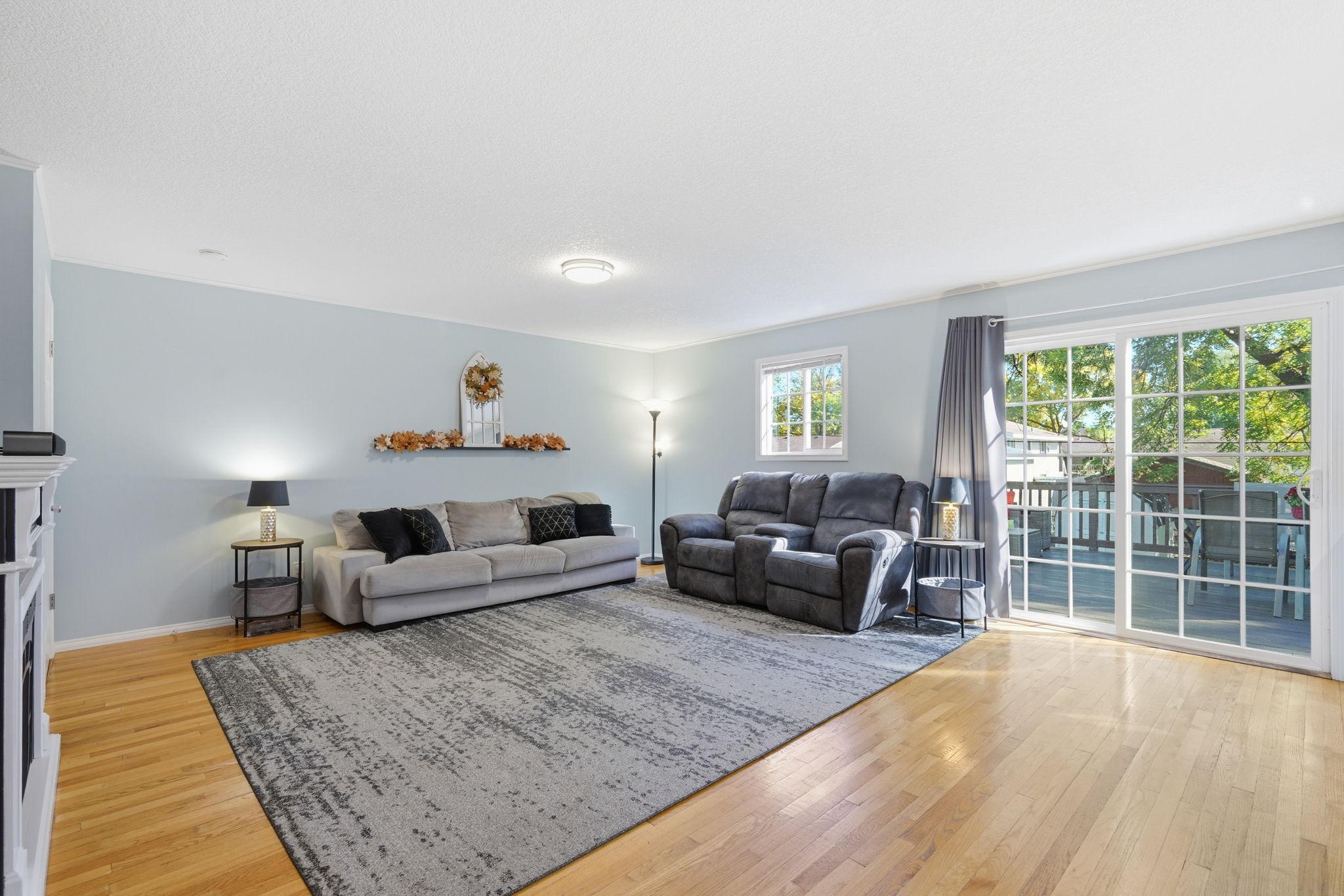 Open main level is spacious and inviting w/ hardwood floors and excellent natural light