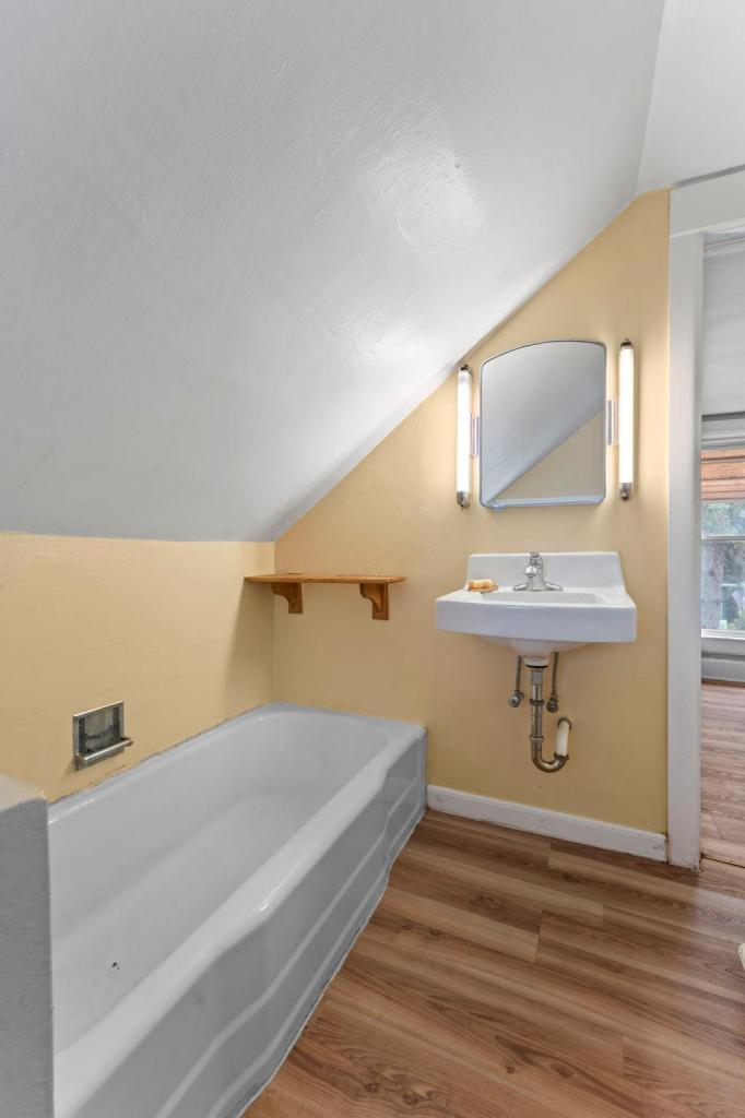 Upper level full bathroom with a separate tub and shower