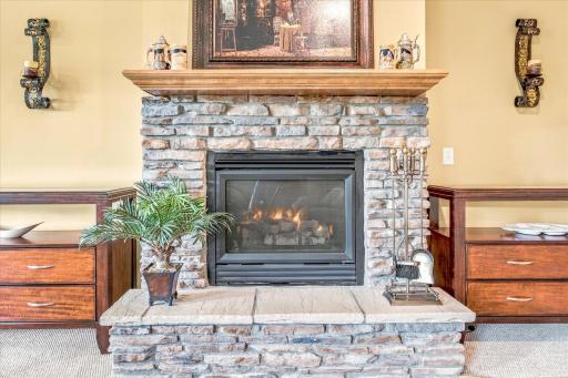 Stone surround gas fireplace in the lower