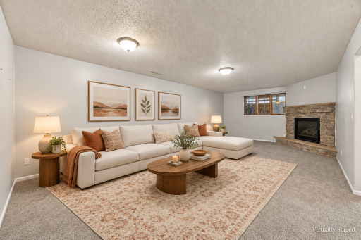 Inviting cream sectional by the fireplace.png