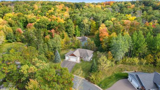 Colorful, mature trees surround this home