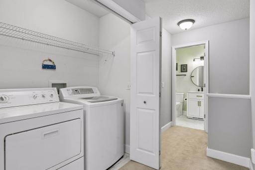 The upper level laundry closet offers a smart use of space with a washer, dryer, and built in shelving for added storage, making laundry day a little easier!