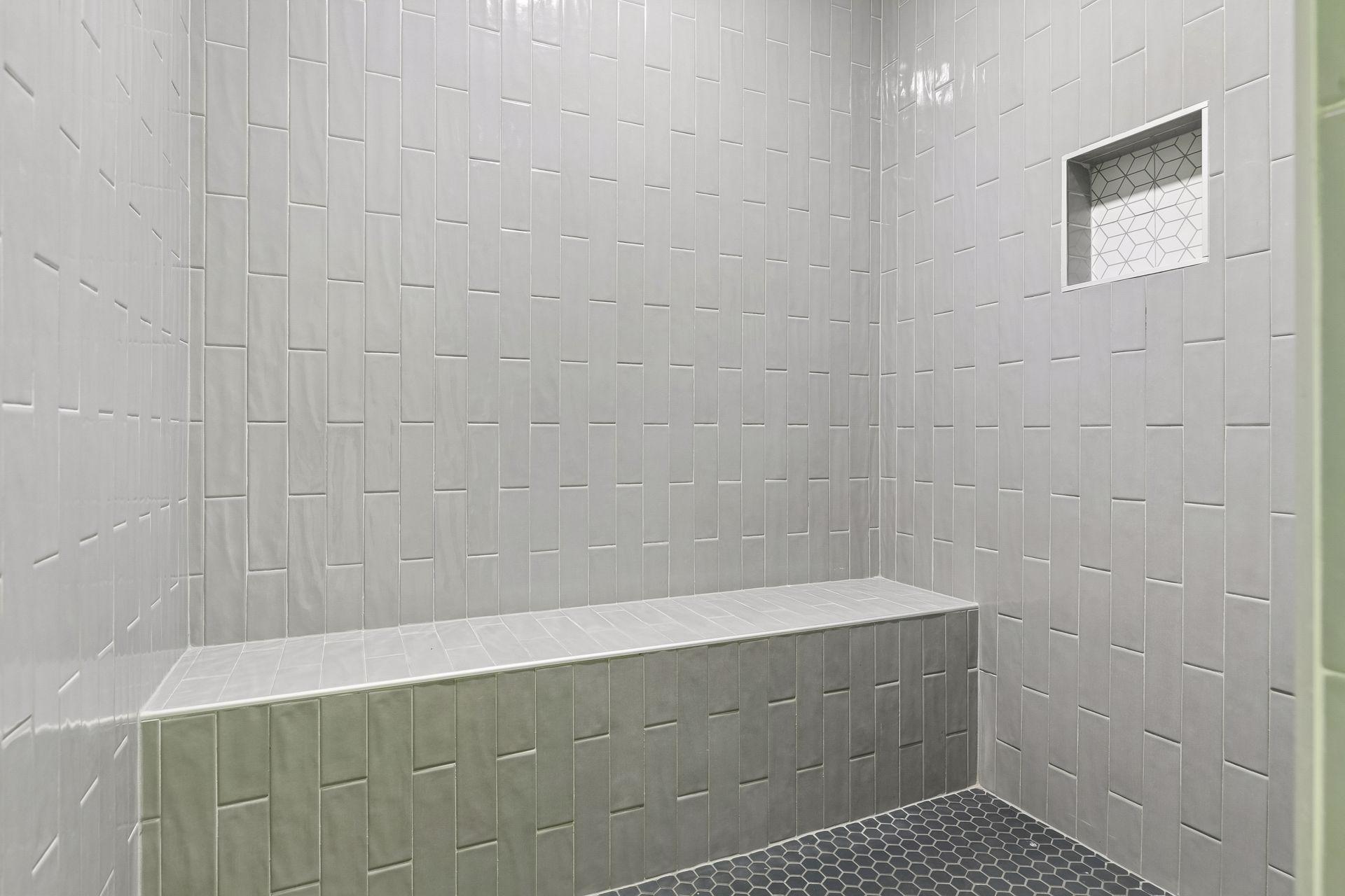The expansive 6' x 5' custom tiled shower is a standout feature and a must see!