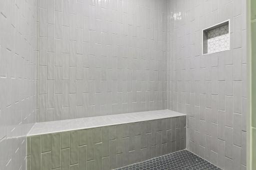 The expansive 6' x 5' custom tiled shower is a standout feature and a must see!