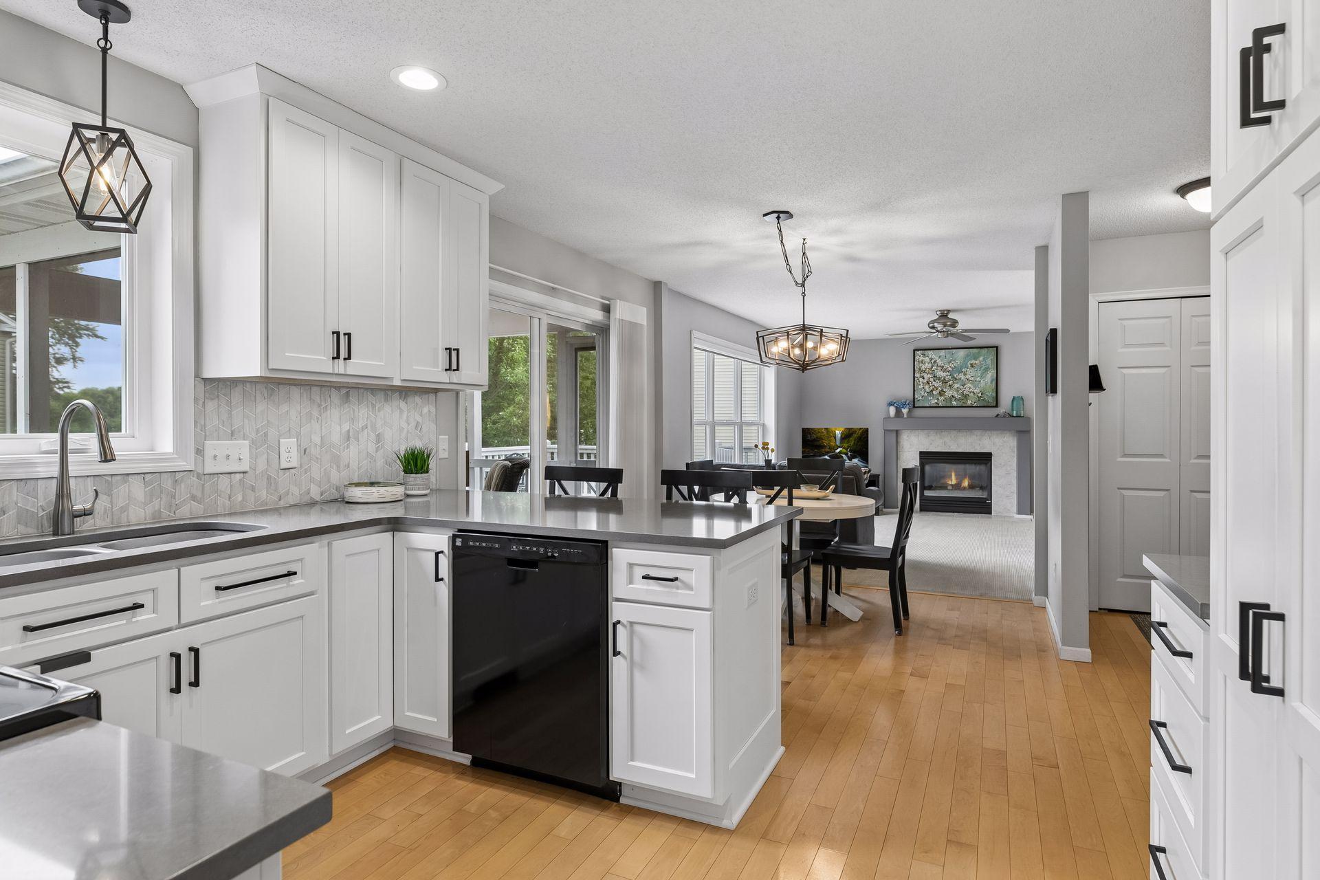 An open layout connects the kitchen to the informal dining space and family room beyond, creating a cohesive setting for everyday living and entertaining.