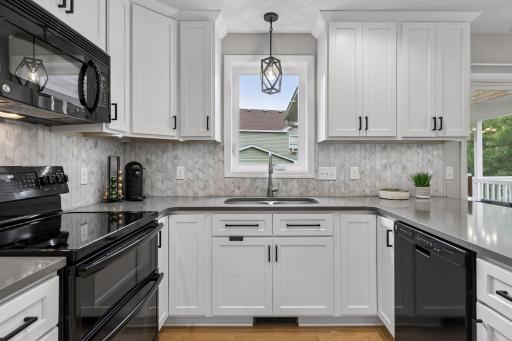 Thoughtful details shine throughout the kitchen, from the stylish pendant light over the double sink to the tile backsplash and double oven.