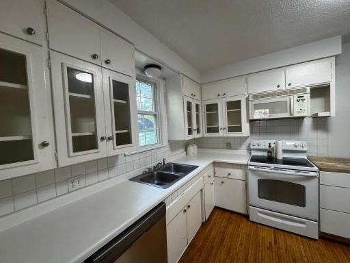 New sink and lower cabinets to be installed prior to closing.