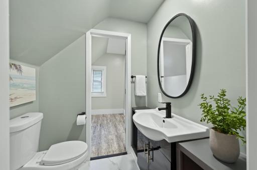 Beautifully refreshed half bathroom on the upper level