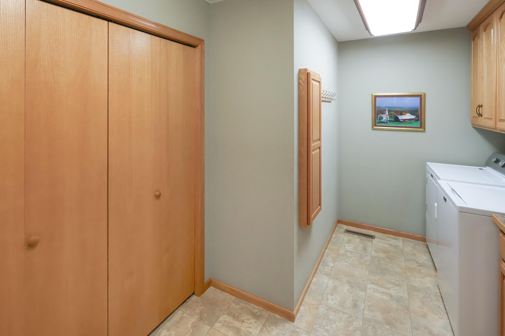 Great laundry and mudroom area with storage and a sink.