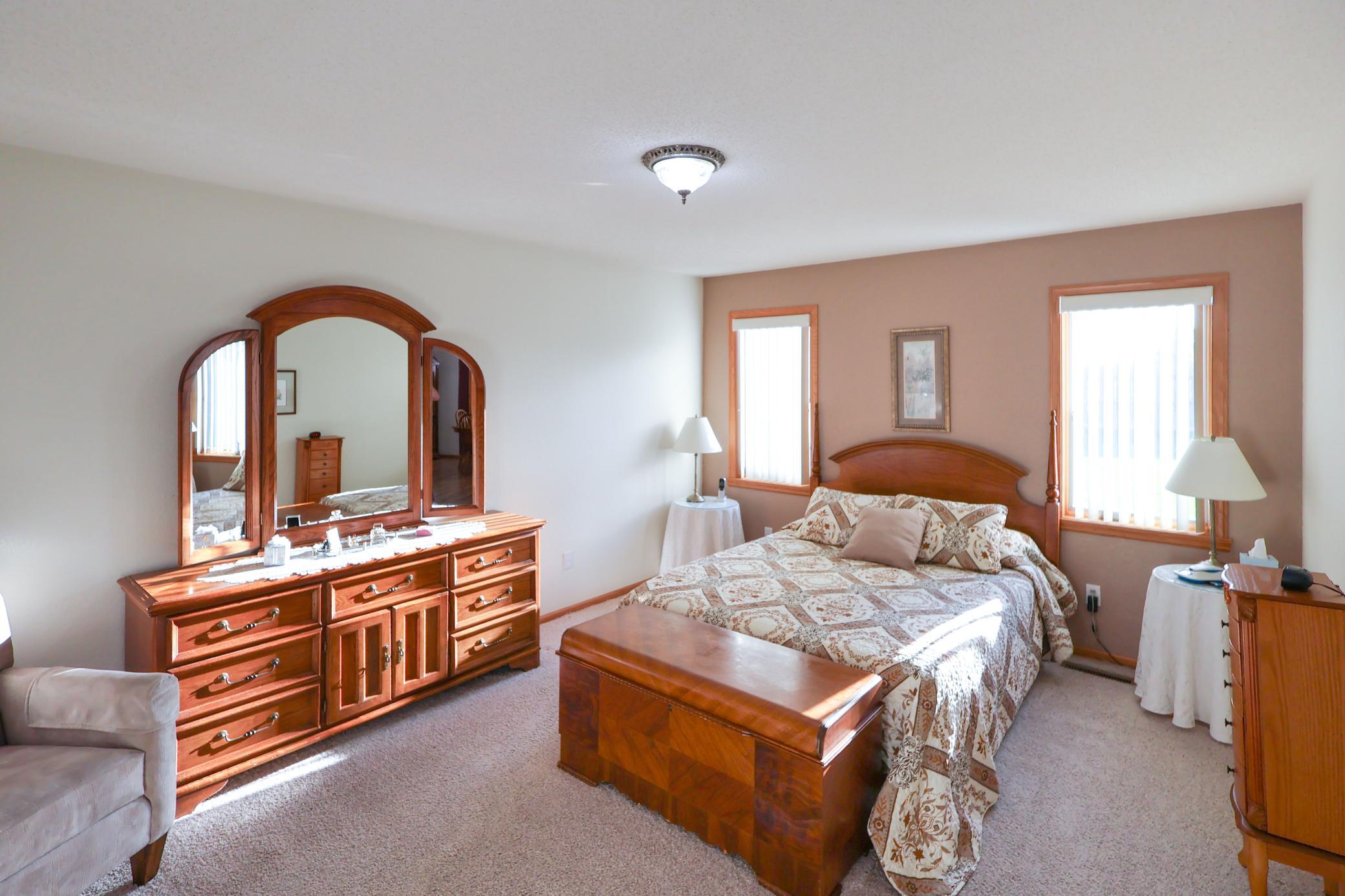 The spacious primary bedroom offers lots of natural light and a private bathroom.