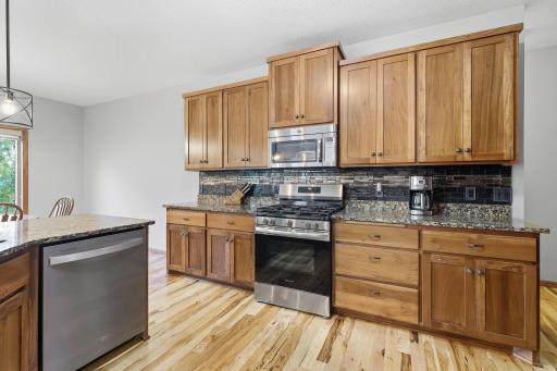 Gorgeous granite countertops with beautiful wood cabinetry with pullout drawers throughout.