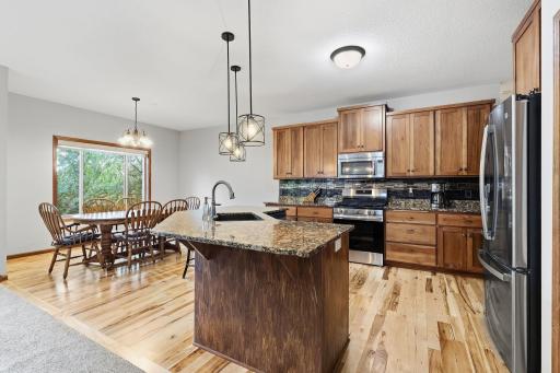 Gleaming hardwood floors add warmth and compliment the kitchen and dining space.