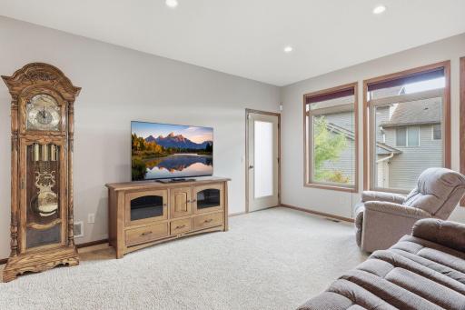 Another angle of the living room that has the door leading outside to the maintenance free deck.