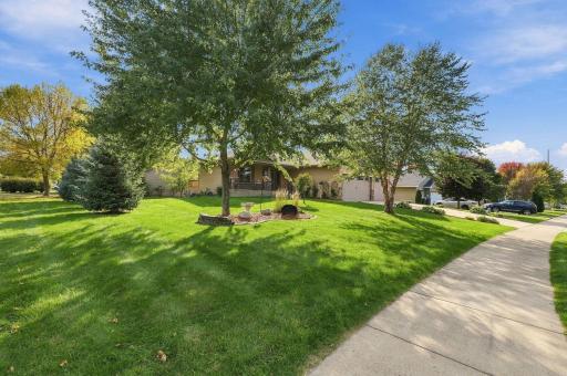 Beautifully treed and landscaped corner lot also has the sidewalk on this side of the property.