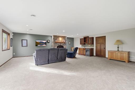Also featured in the family room is a wet bar with granite countertops and a lovely stone gas fireplace