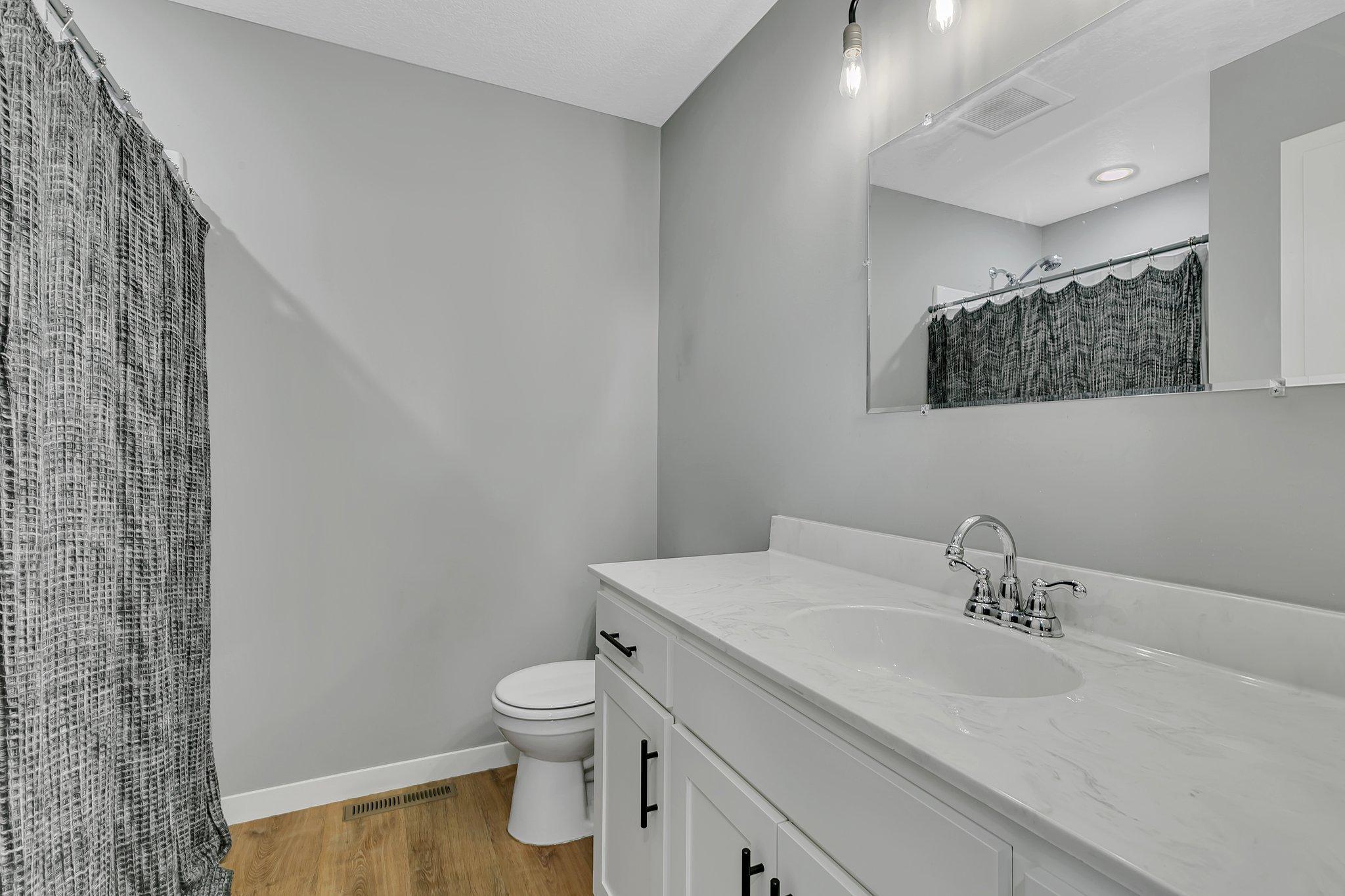 En suite bath has a spacious shower and linen closet