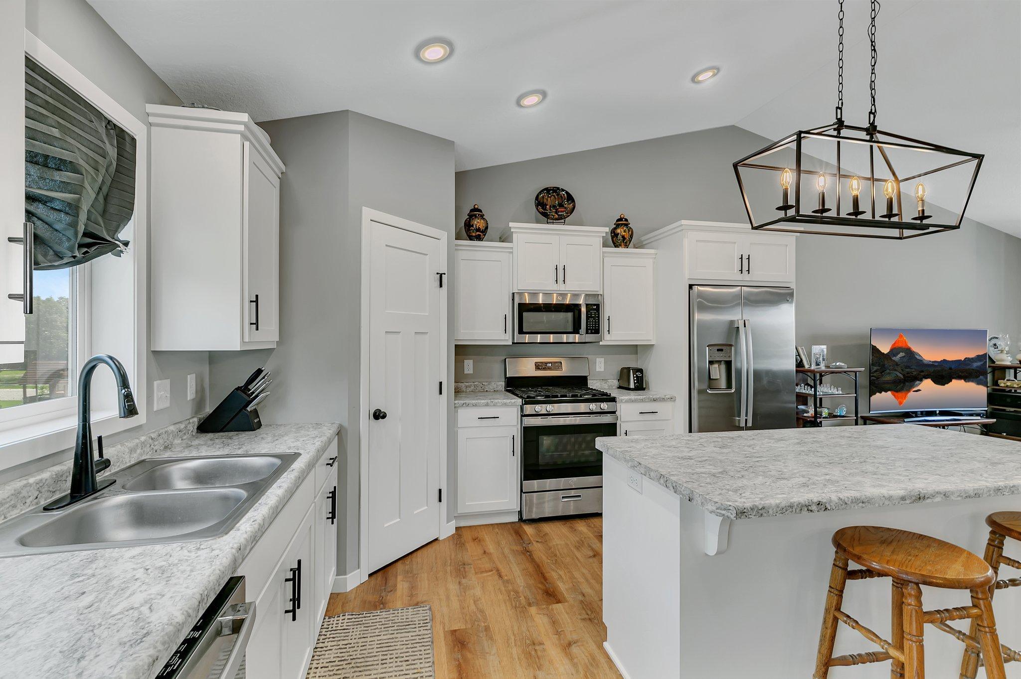 White cabinets and a walk-in pantry