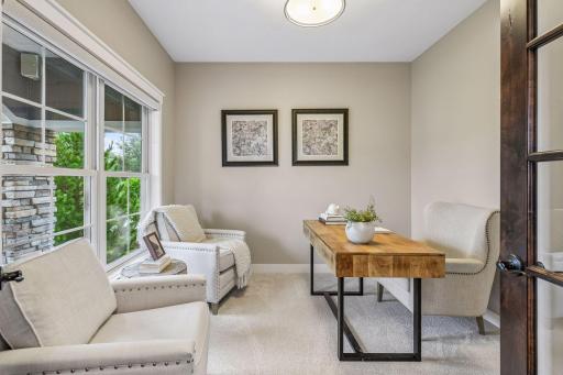 Private main level office with French doors, large windows, and abundant light.
