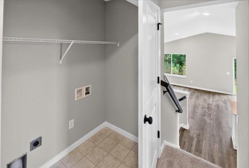 Upper Level Laundry. Photo taken of another home with similar plan and finishes.
