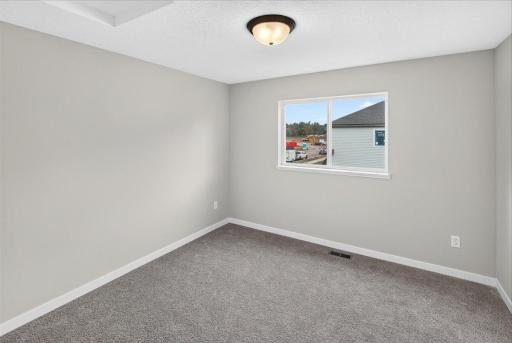 Bedroom 2. Photo taken of another home with similar plan and finishes.