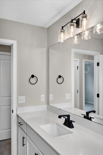 Walk Thru Bathroom. Photo taken of another home with similar plan and finishes.
