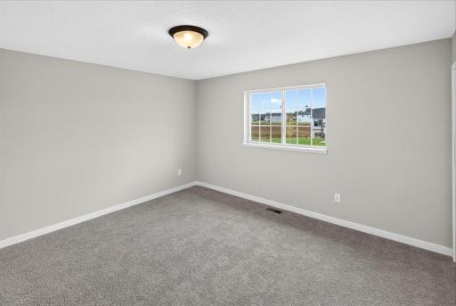 Primary Suite. Photo taken of another home with similar plan and finishes.