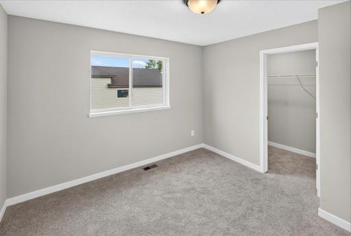 Bedroom 2. Photo taken of another home with similar plan and finishes.