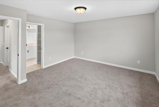 Primary Suite. Photo taken of another home with similar plan and finishes.