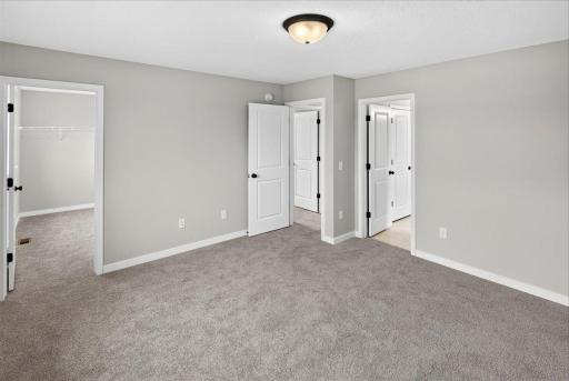 Primary Suite. Photo taken of another home with similar plan and finishes.
